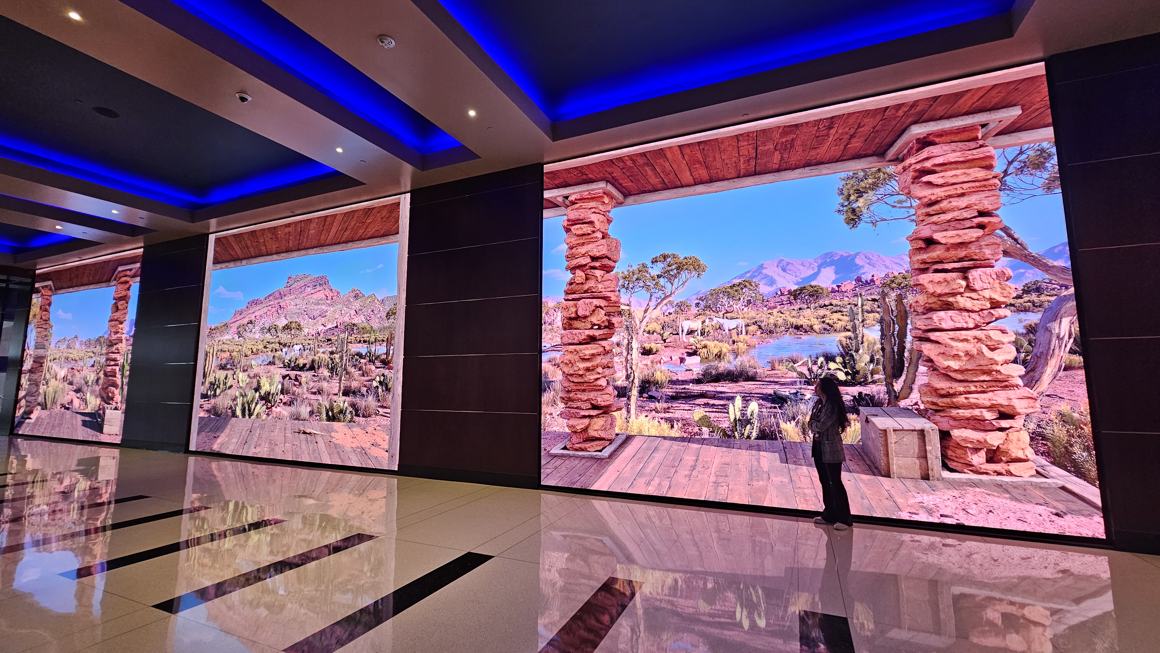 Large-scale immersive LED desert landscape installation spanning multiple panels in a casino lobby